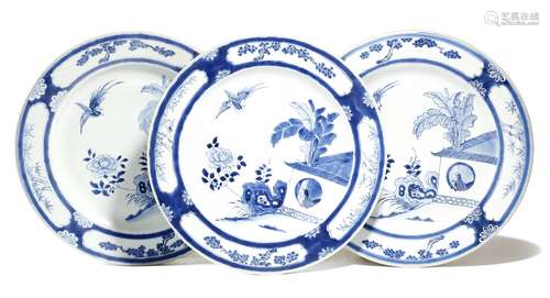 A set of three Chinese porcelain blue and white shallow dishes, painted with a bird in the house