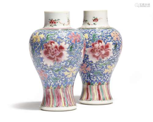 A small pair of Chinese porcelain famille rose baluster vases, decorated with flowers on a scrolling