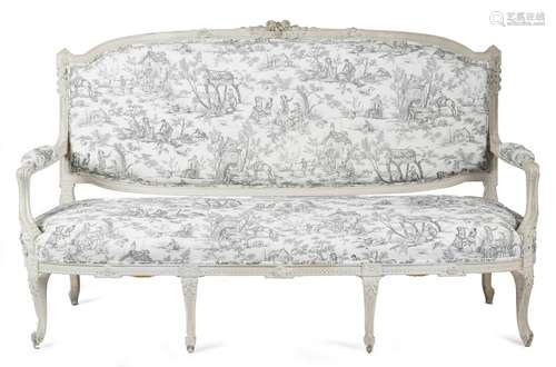 A French white painted canapé in Louis XVI style, the padded back, seat and armrests covered in en