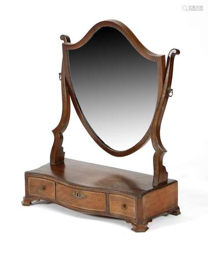 A mahogany dressing table mirror, the shield shape plate above a serpentine box base fitted with