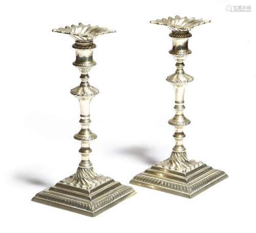 A pair of late 18th century paktong candlesticks, each with a fluted detachable drip-pan above a