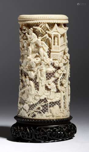 λ A late 19th century Chinese Canton carved ivory tusk vase, with a reticulated ground and decorated