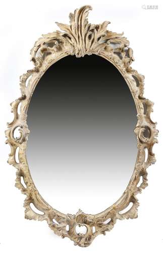 A pair of composition wall mirrors in early George III style, each with an oval plate, within a