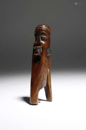 A mid-18th century treen primitive lever action nutcracker, in the form of a man wearing a hat and