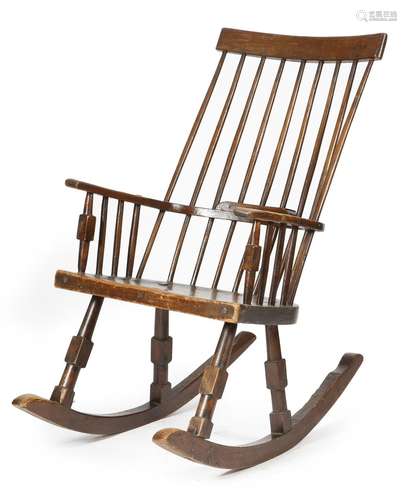 A 19th century oak and elm Windsor rocking chair, with a comb top rail and an ash stick back, on