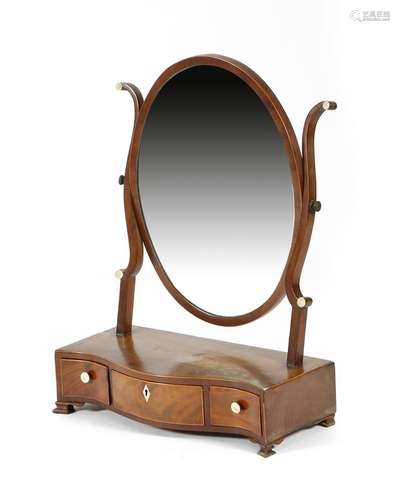 A George III mahogany dressing table mirror, inlaid with boxwood stringing, the later oval plate