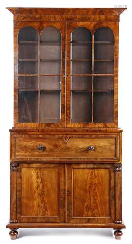 An early Victorian mahogany secrétaire bookcase, flame veneered, the detachable cornice above a pair