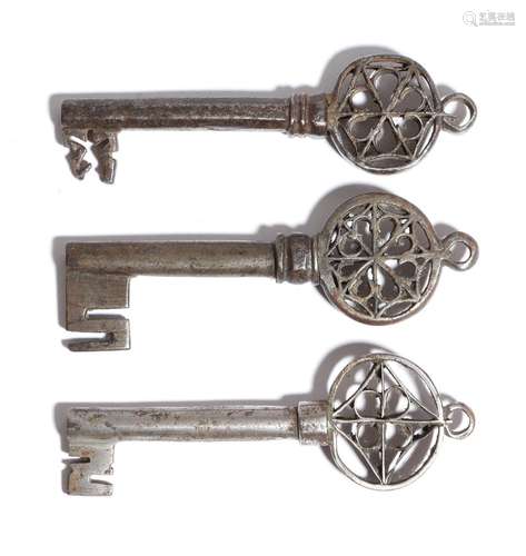 Three Italian Venetian keys, each with a pierced Gothic bow and with a ring for suspension, all with