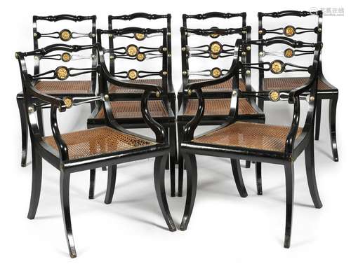 A set of eight Regency ebonised dining chairs by John Gee, each with a pierced ladder back inset