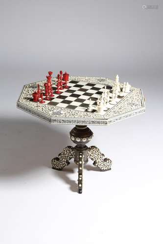 λ An Anglo-Indian ivory and horn miniature games table, the octagonal top inlaid with a