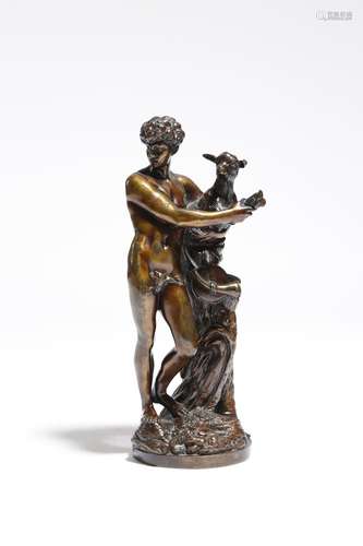 An early 19th century bronze group, of a scantily clad young shepherd holding a lamb, standing on