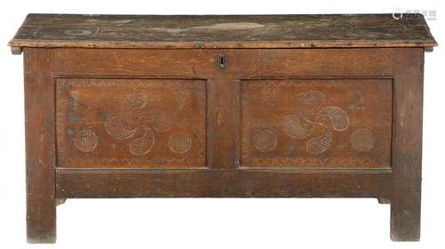 An early 18th century oak and pine coffer, with a vacant interior, the twin panelled front pin wheel