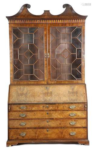 λ A George III mahogany bureau bookcase, inlaid with barber's pole stringing, with a swan neck