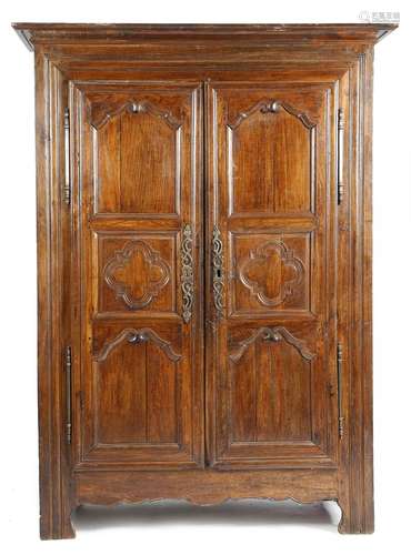 A late 18th century French provincial chestnut armoire, the later detachable cornice above a pair of