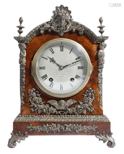 A late Victorian walnut mantel clock, the eight day German movement by Lenzkirch striking on two