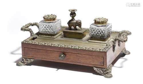 λ A Regency rosewood and brass mounted inkstand, with a pair of cut-glass inkwells with rosette