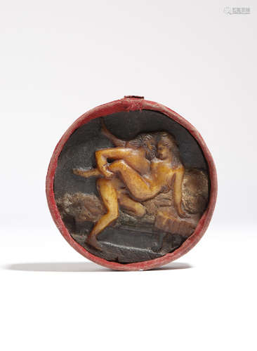 An Italian wax erotic rondel, polychrome decorated with a love making couple, in a velvet covered