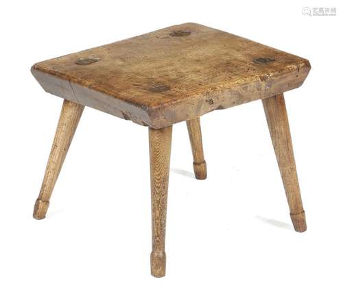 A 19th century sycamore dairy stool, on turned ash legs, 30.6cm high, 35.2cm wide, 33.4cm deep.