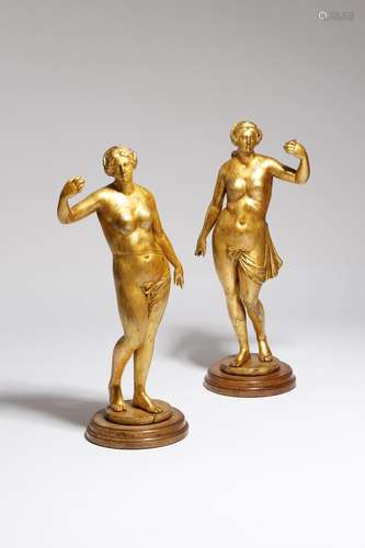 A pair of giltwood figures, of scantily clad maidens, possibly 17th / 18th century and later, on a