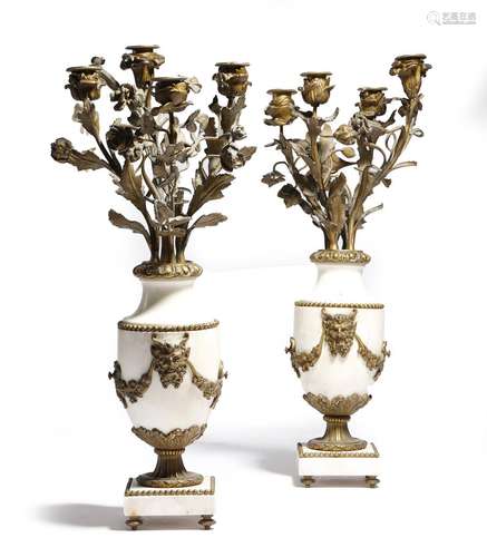 A pair of French white marble and gilt brass mounted candelabra in Louis XVI style, the urn body