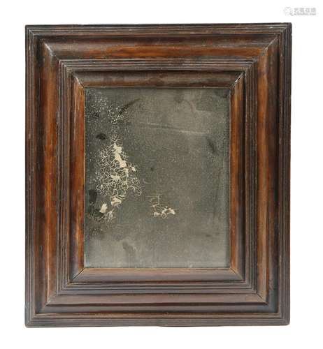 An early 18th century walnut wall mirror, the later rectangular plate with a bevelled edge, within a