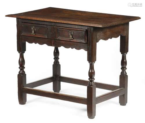 A Queen Anne oak side table, the boarded top with a moulded edge, above a twin panelled frieze