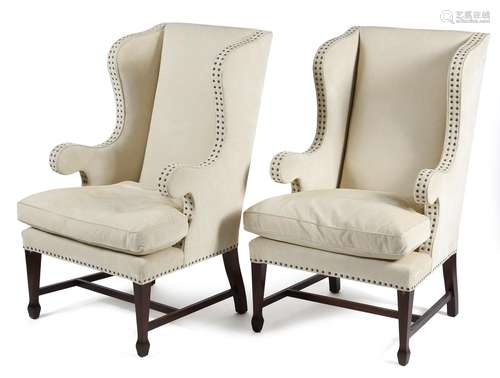 *A pair of modern wing armchairs in George III style, each covered in studded ivory corduroy, on