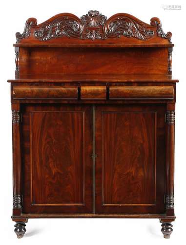 A William IV mahogany chiffonier, the raised back carved with scrolls and leaves, with a shelf on