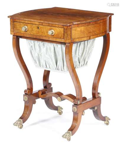 A Regency mahogany sewing table, inlaid with stringing and with gilt brass mounts, the crossbanded