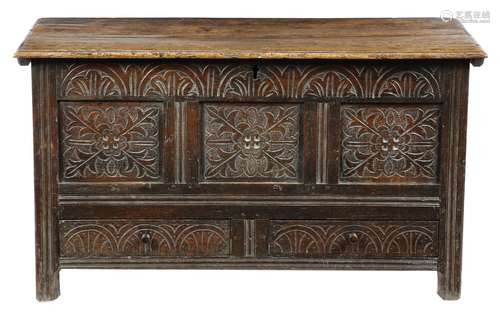 An early 18th century oak mule chest, the interior with a lidded till, the triple panelled front