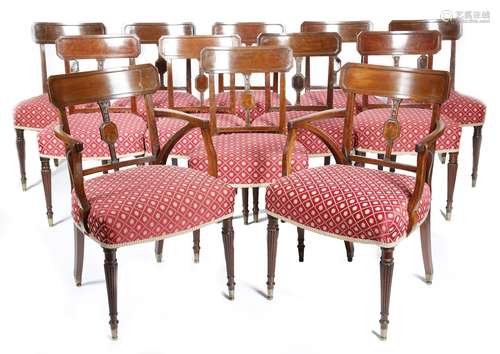 A set of twelve Regency mahogany dining chairs, each with a curved tablet top rail, above a single