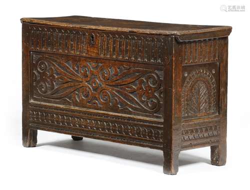 A small early 17th century oak coffer, the hinged lid with a moulded edge revealing a till, above an