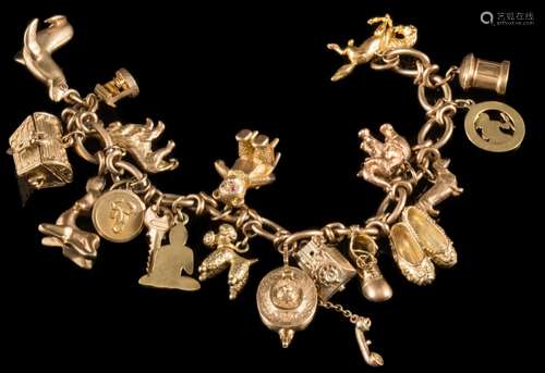 A 9ct gold charm bracelet: with nineteen various attached charms to include seated bear,