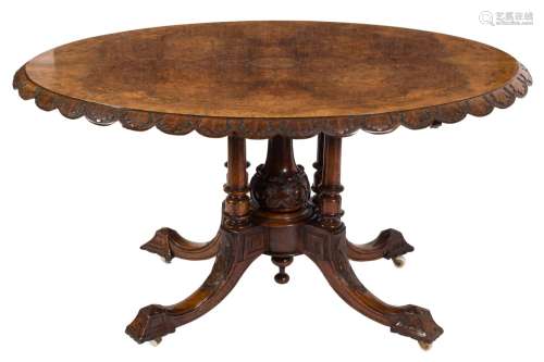 A Victorian carved walnut and inlaid oval breakfast table:,