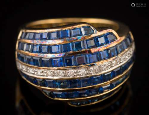 A sapphire and diamond domed cluster ring: set with calibre-cut sapphires and centring a single row