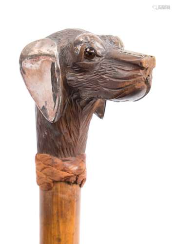 A late 19th /early 20th century walking stick: the carved wood handle in the form of a dog's head