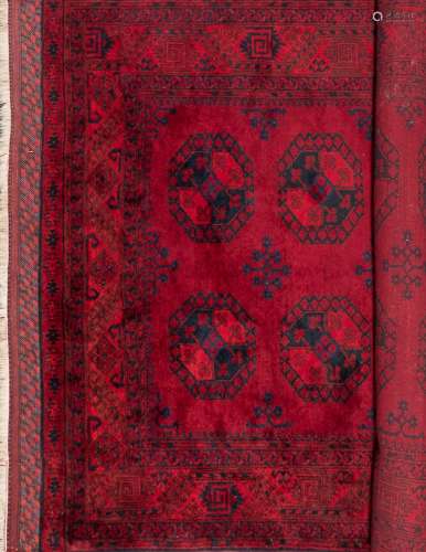 An Afghan carpet:, of traditional design and colours,