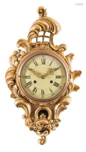 A carved giltwood cartel wall clock: of cartouche-shaped outline with pierced lattice,