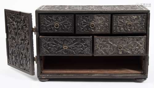 An Eastern carved ebony table top cabinet: of rectangular outline,