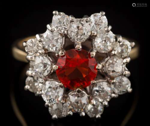 A fire opal and diamond circular cluster ring: the central circular fire opal approximately 5.