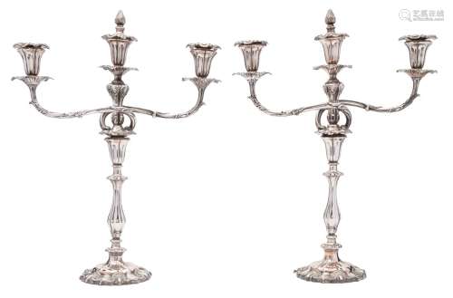 A pair of Victorian silver plated twin-branch candelabra: the urn shaped nozzles with foliate