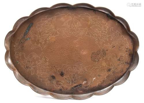 A Newlyn copper tray: of oval outline with wavy edge border,