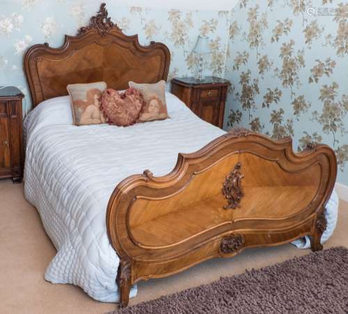 A French carved walnut double bed in the Louis XV provincial taste:,