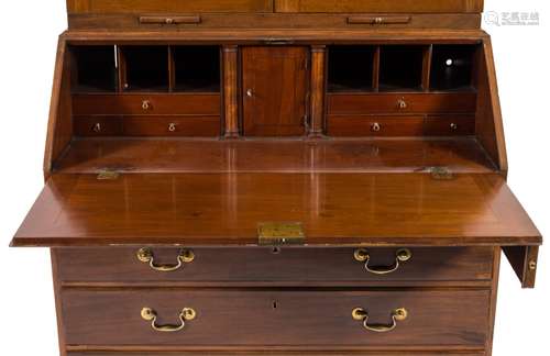 A George III mahogany bureau bookcase:, the upper part with a moulded dentil cornice,