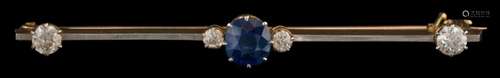 A sapphire and diamond mounted bar brooch: the cushion shaped sapphire approximately 6mm long x 5.