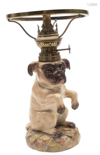A Continental porcelain table lamp in the form of a begging pug: modelled on it's hind quarters