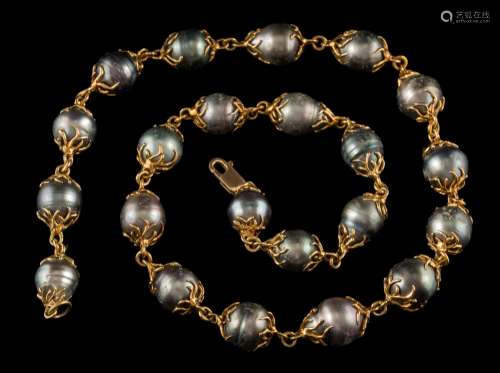 A caged cultured black baroque pearl,