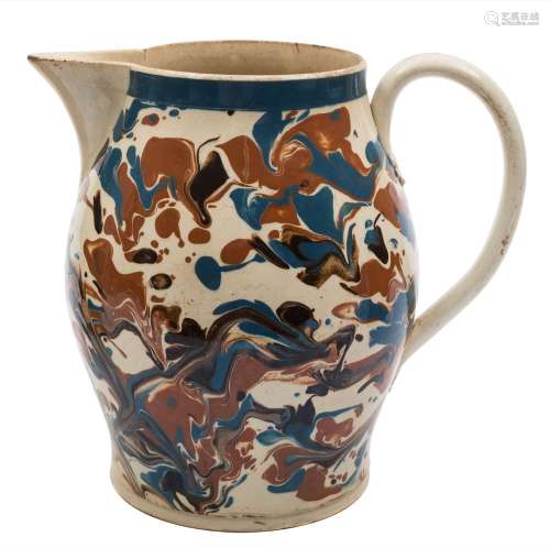 A large late 18th century marbled creamware jug: of baluster form, slip decorated with bold blue,