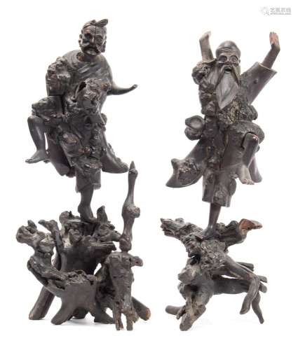 A pair of Chinese rootwood carvings depicting dancing figures: mounted on naturalistic stands,