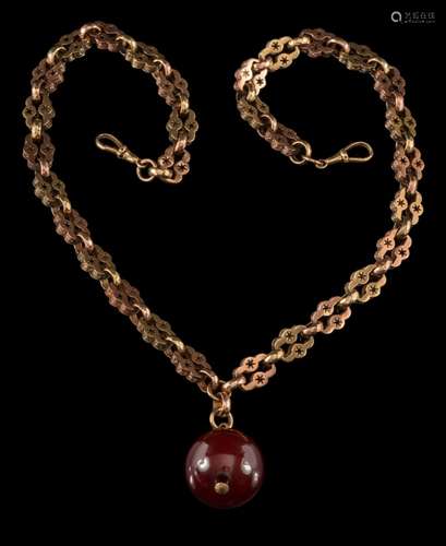 A late 19th century watch chain: with attached red amber bead, 54gms weight of chain.